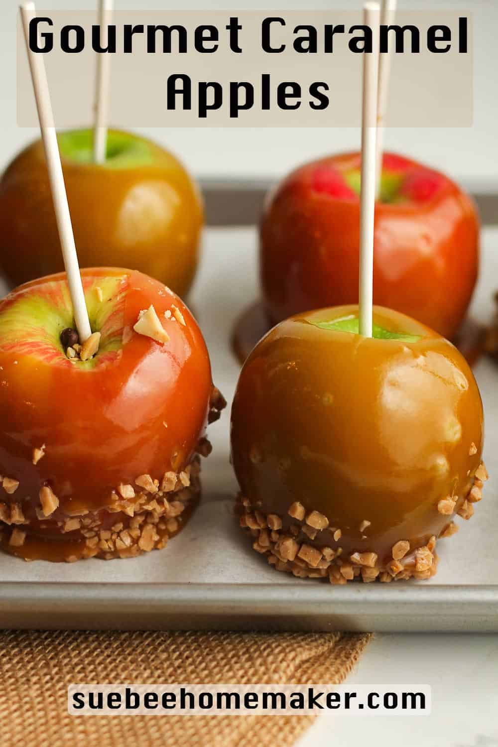 Side shot of caramel apples with toppings.