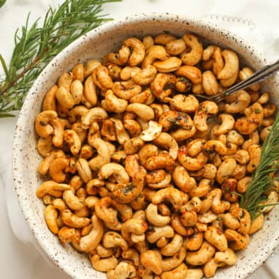 Some rosemary cashews with rosemary sprigs.