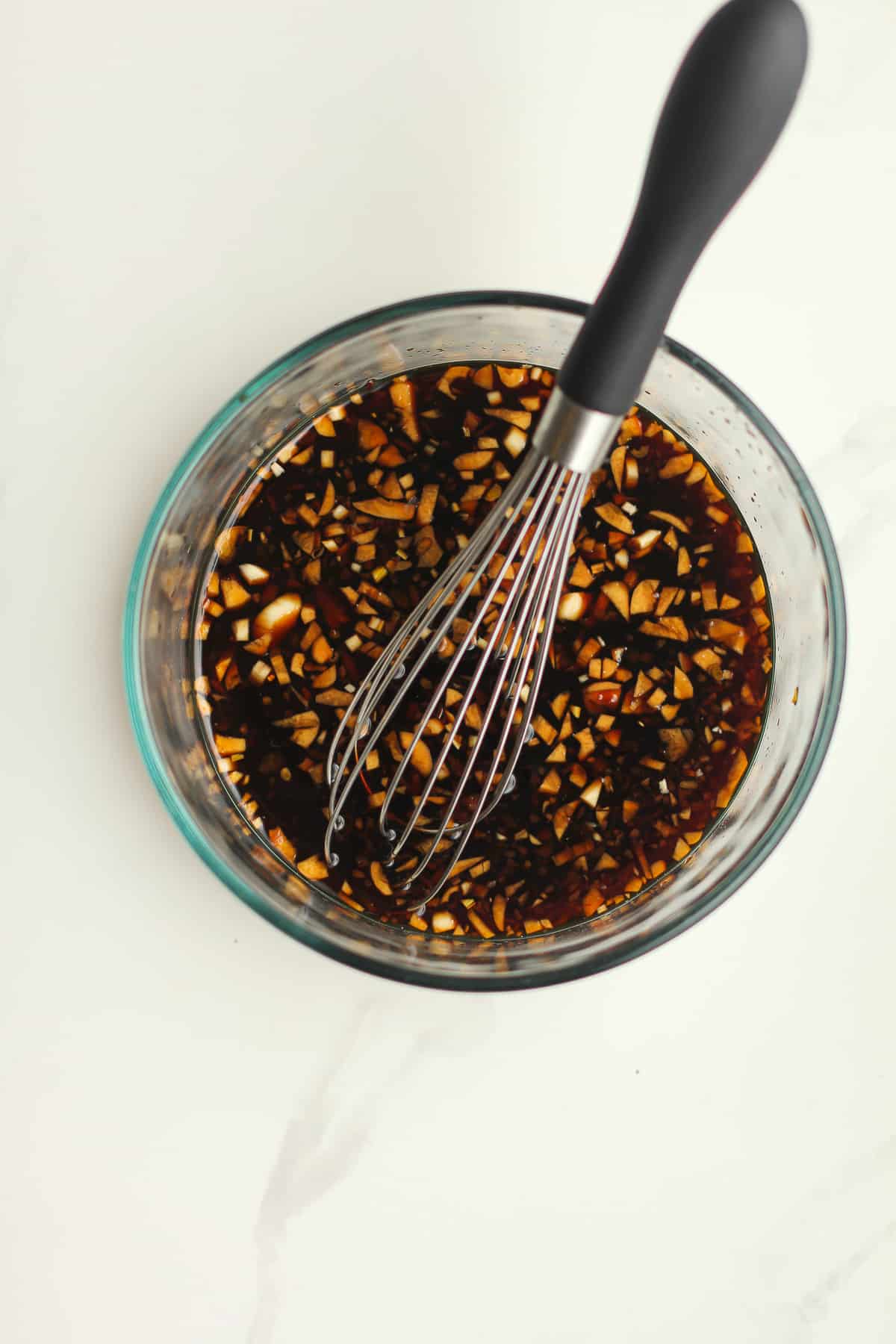 The marinade with a whisk.