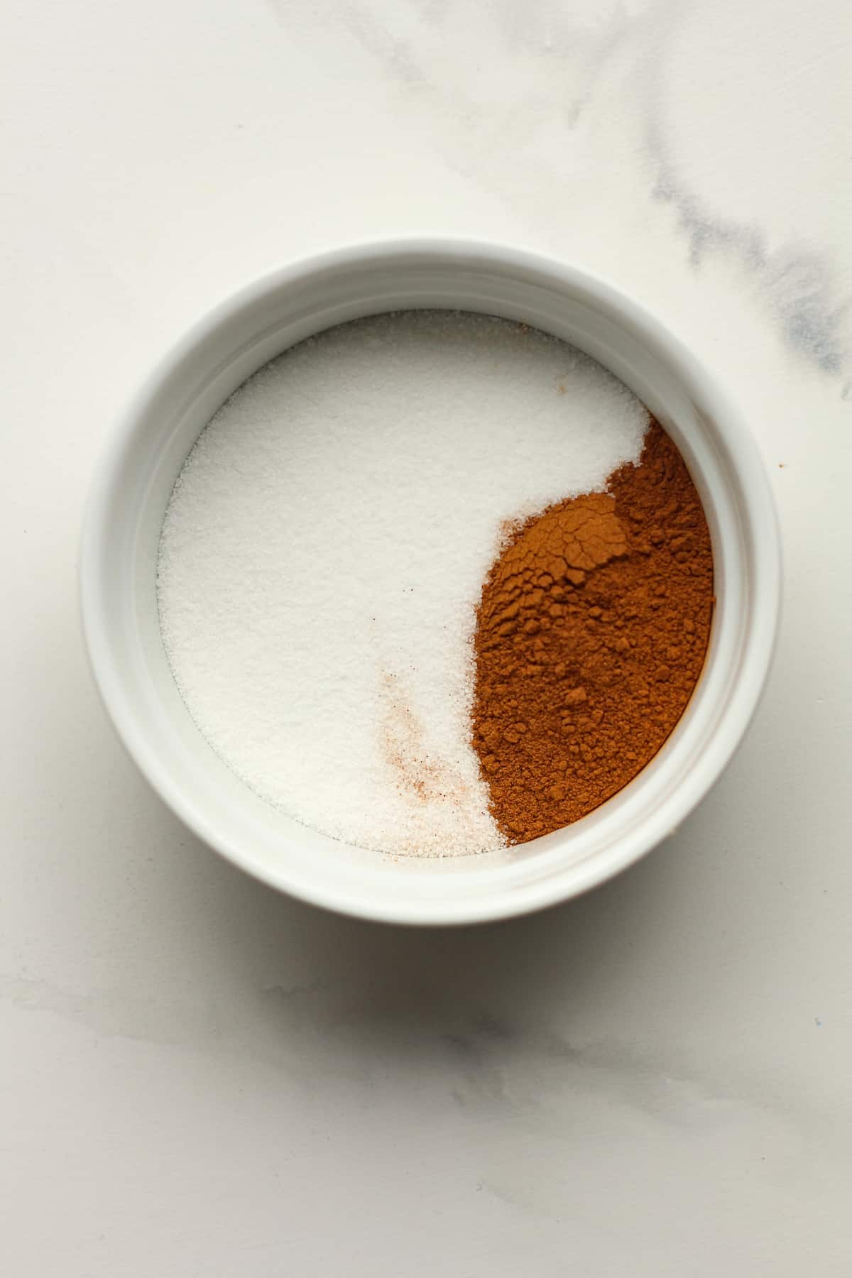 A bowl of sugar and cinnamon.