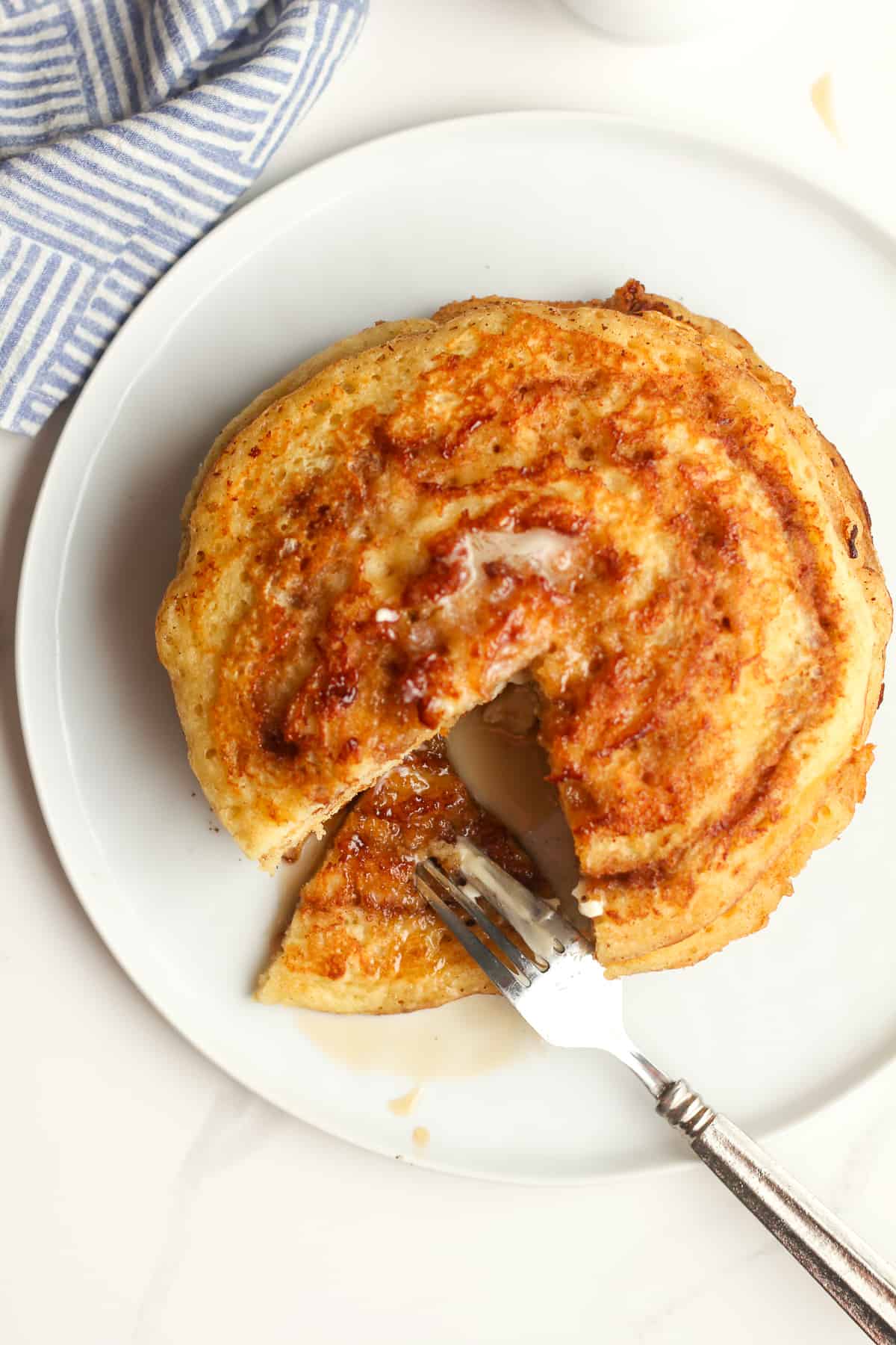 A plate of pancakes, with a triangle out.