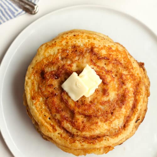 A stack of cinnamon swirl pancakes with butter.