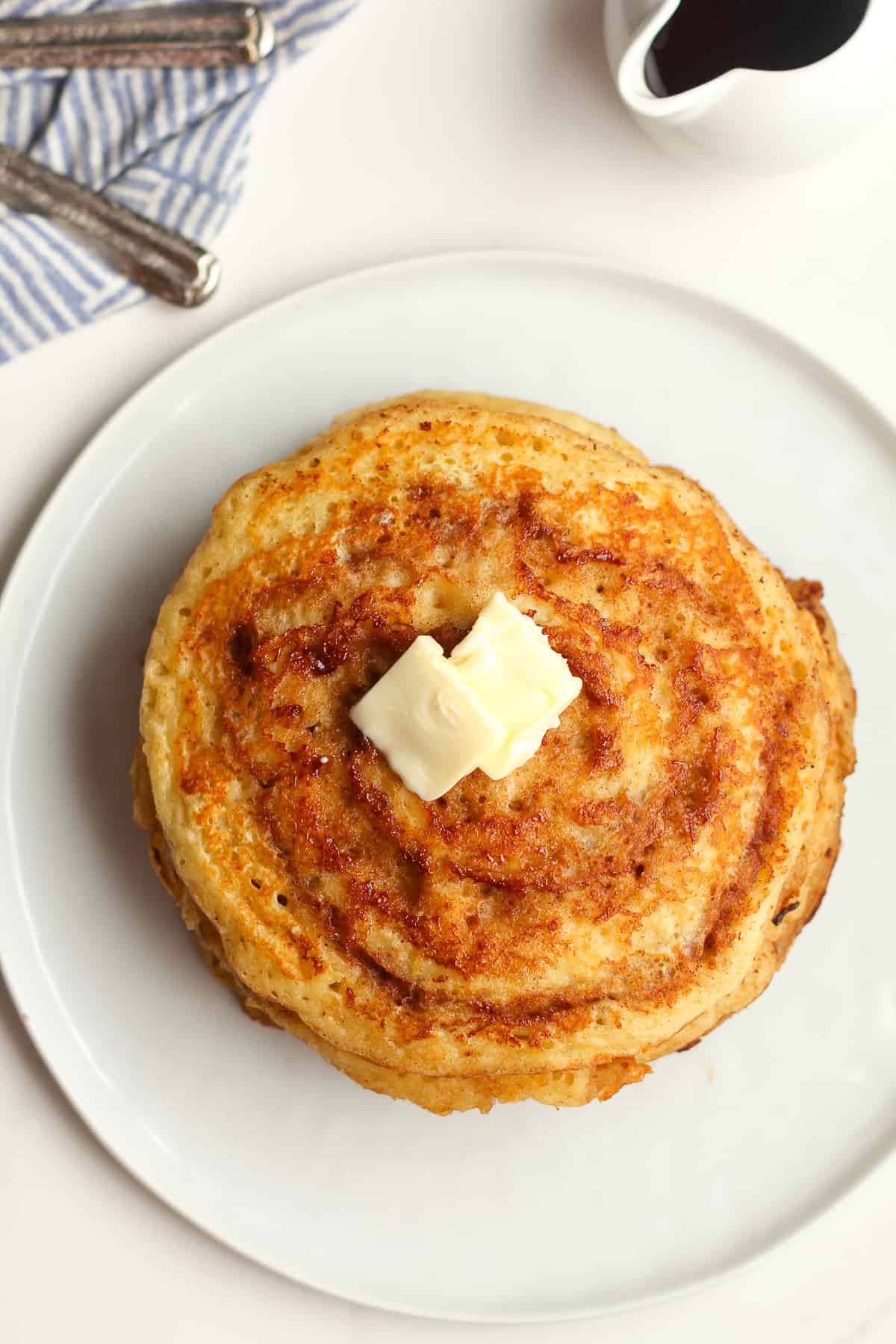 A stack of cinnamon swirl pancakes with butter.