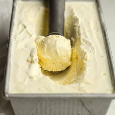A scoop of vanilla bean ice cream in a pan.