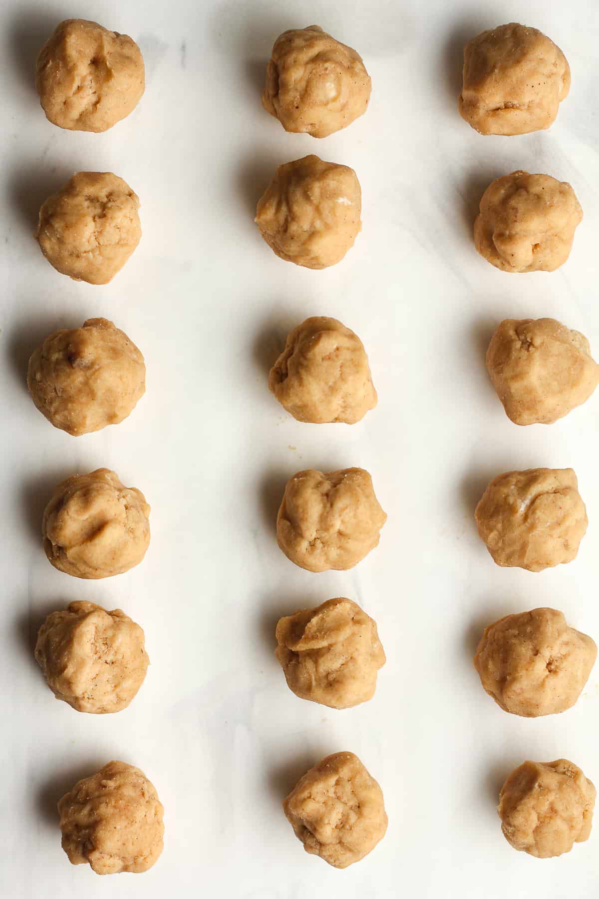 18 cookie balls on a white background.