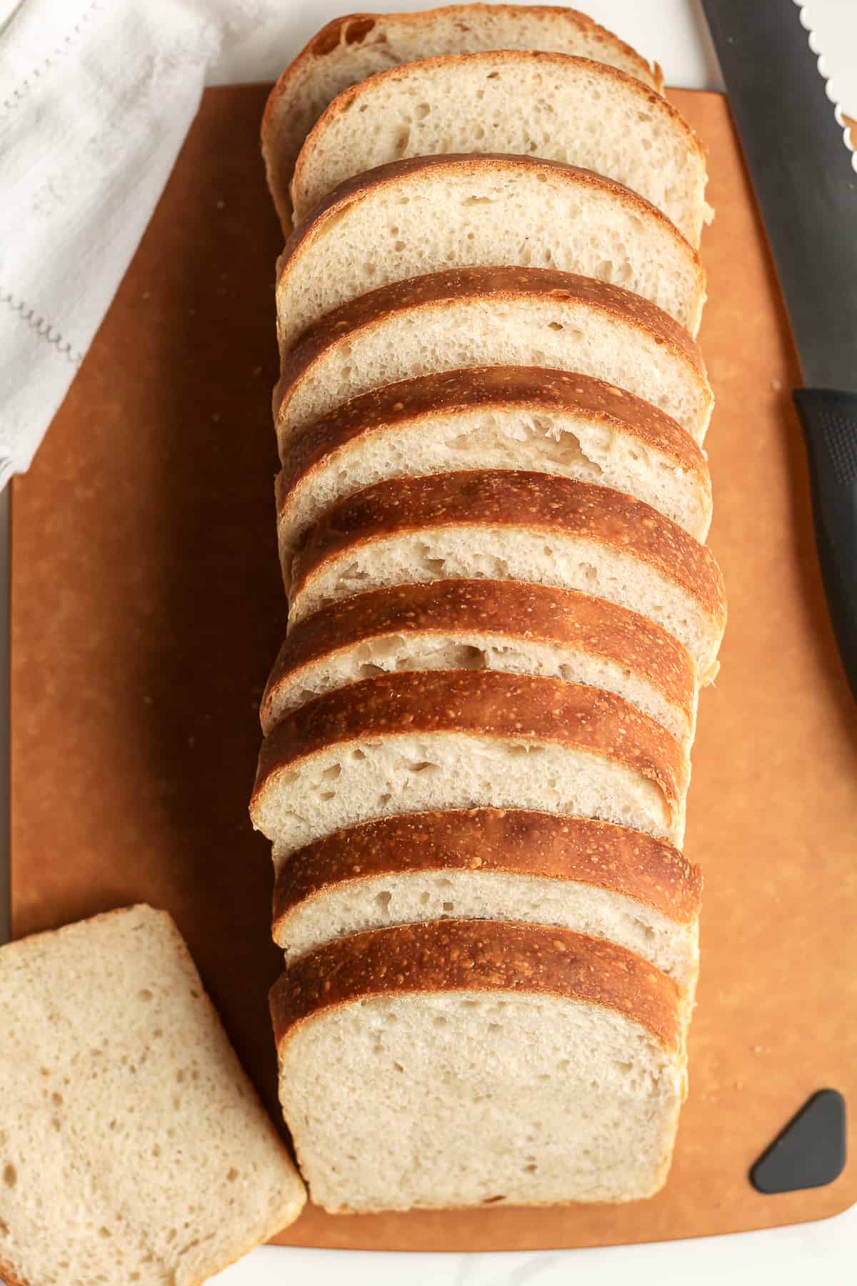 A loaf of sourdough sliced on a board.