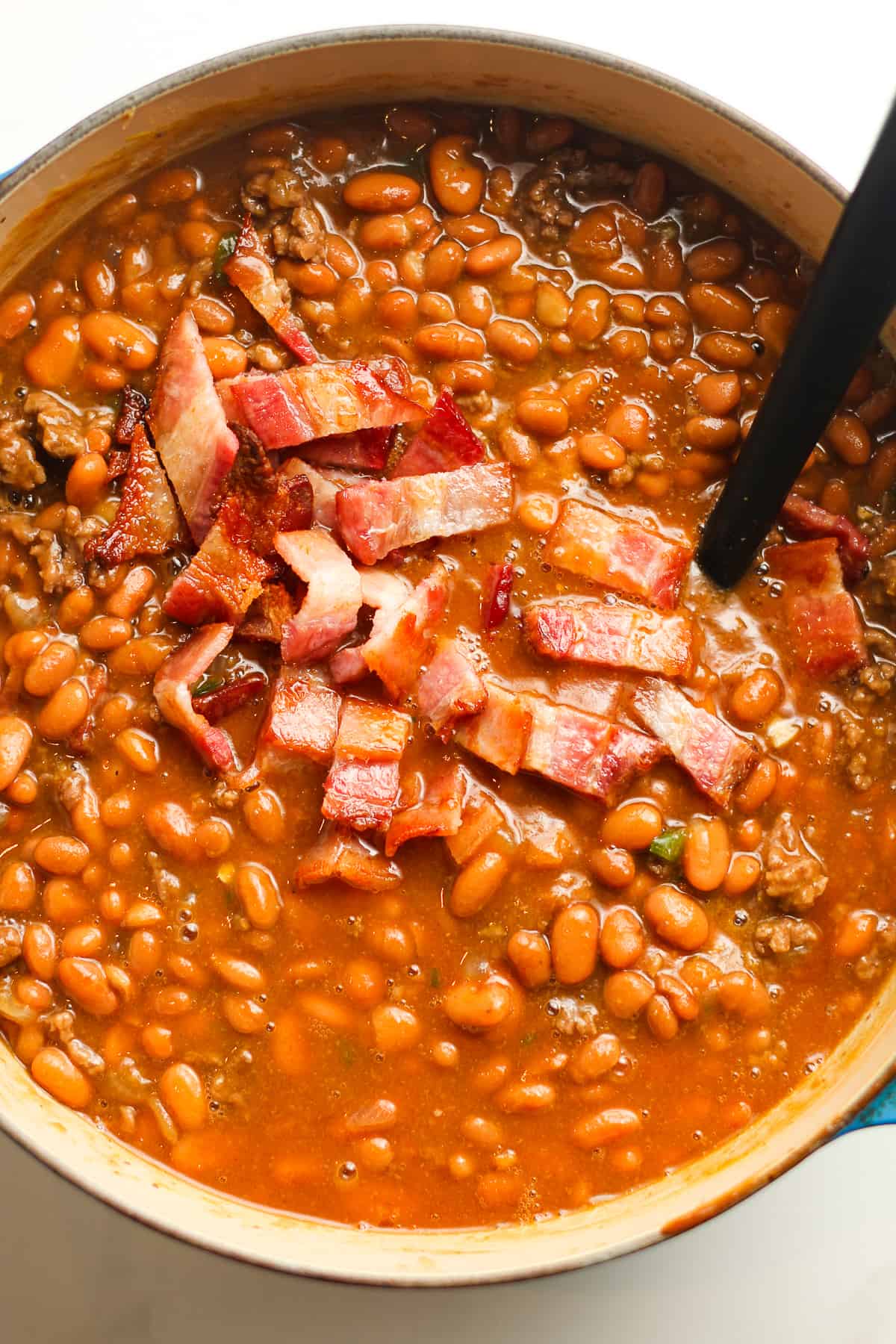 The beans with cooked bacon on top.
