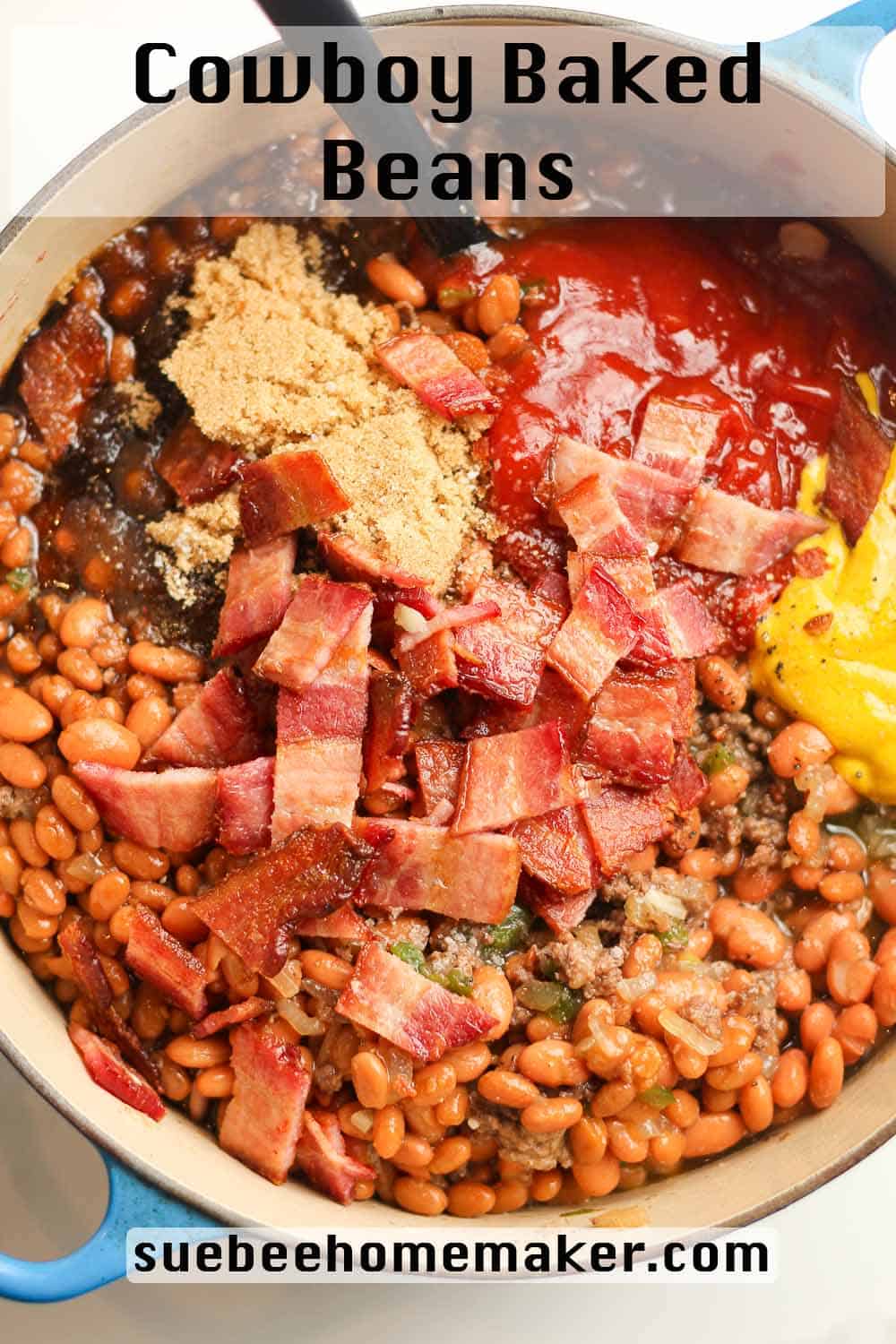 A pot of cowboy baked beans with toppings on top.