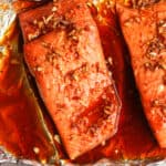 Overhead shot of a chunk of baked salmon with marinade.