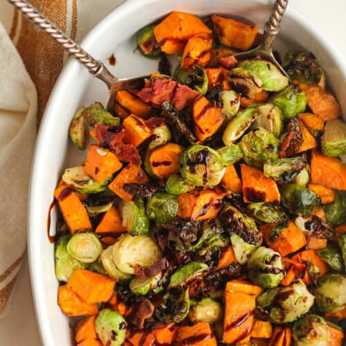 Overhead shot of a dish of balsamic glazed Brussels sprouts and sweet potatoes.
