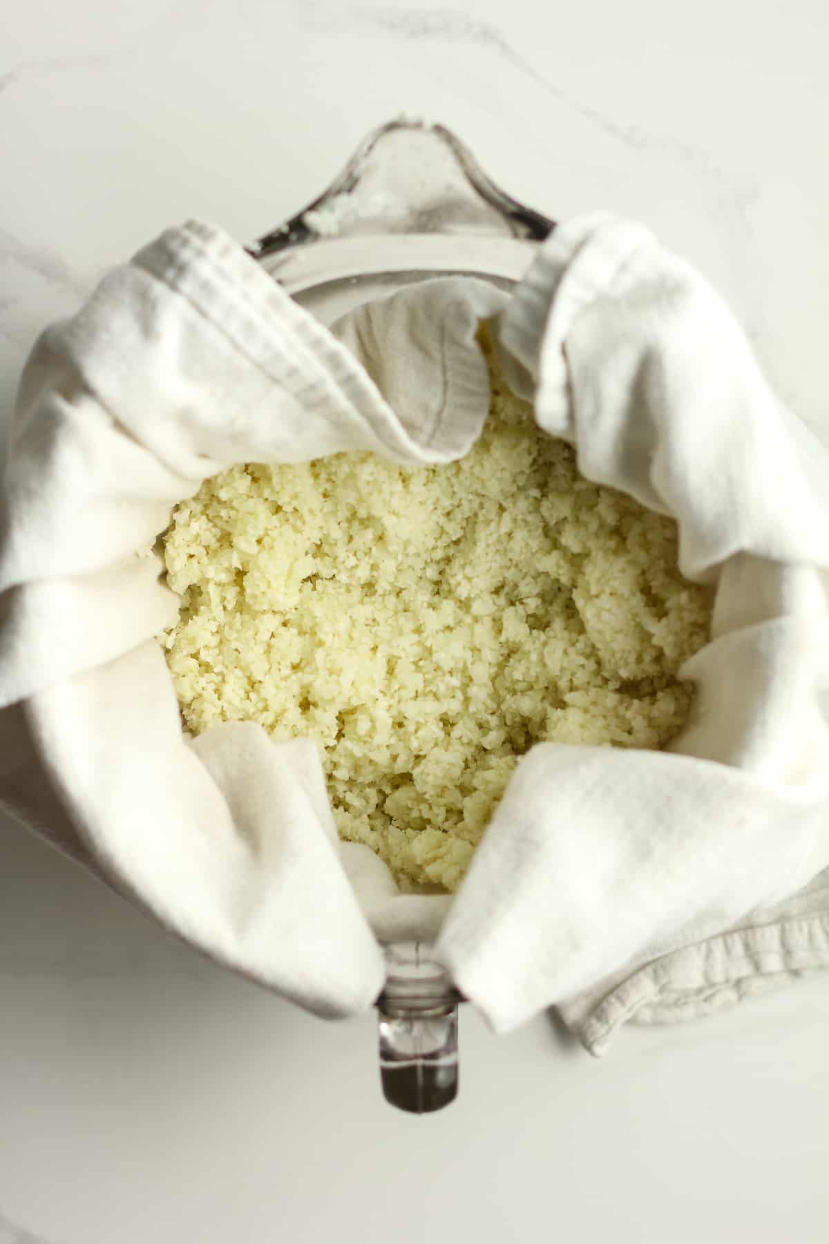 A towel with cooked cauliflower rice.