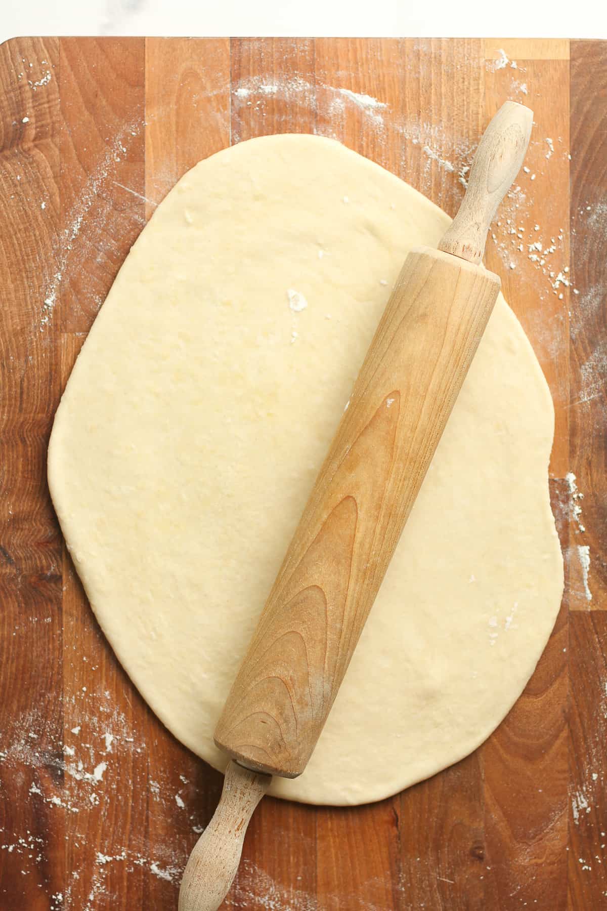 The just rolled out flatbread with a rolling pin.