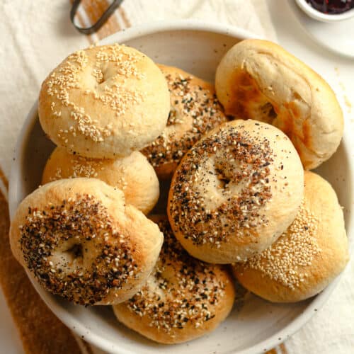 A bowl of bagels on a napkin.