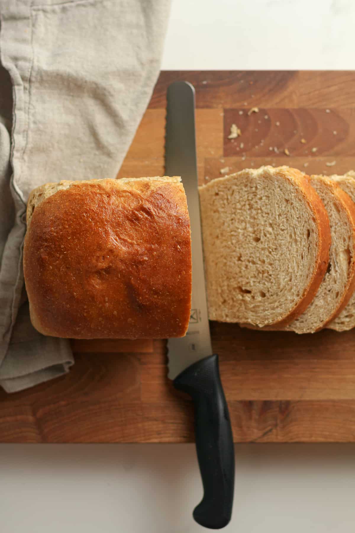 A loaf of bread being sliced.