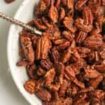 A bowl of caramelized pecans.