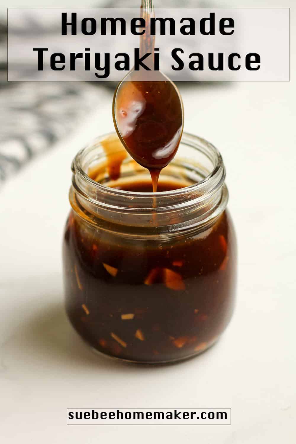 Side shot of a jar of teriyaki sauce with a spoon drizzling the sauce.