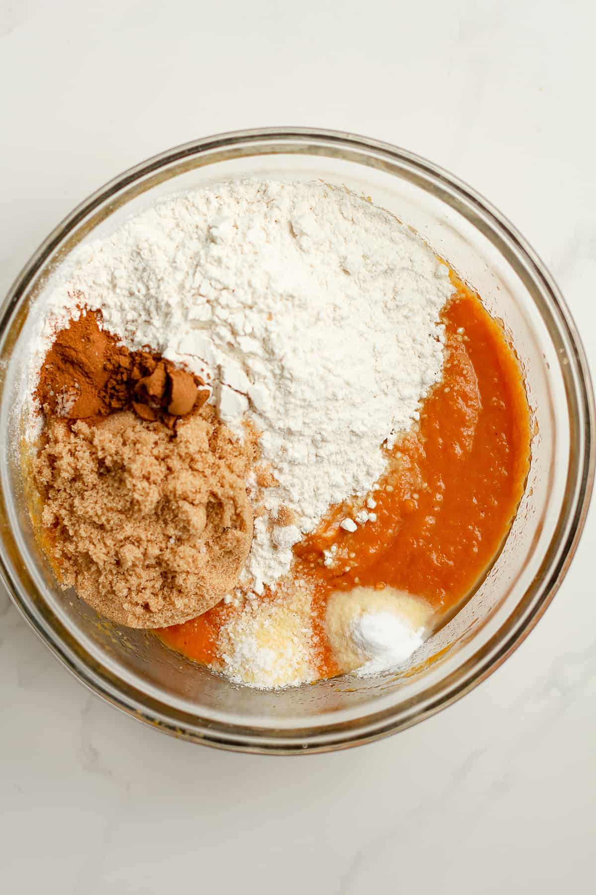 A bowl of the pumpkin batter plus the dry ingredients.