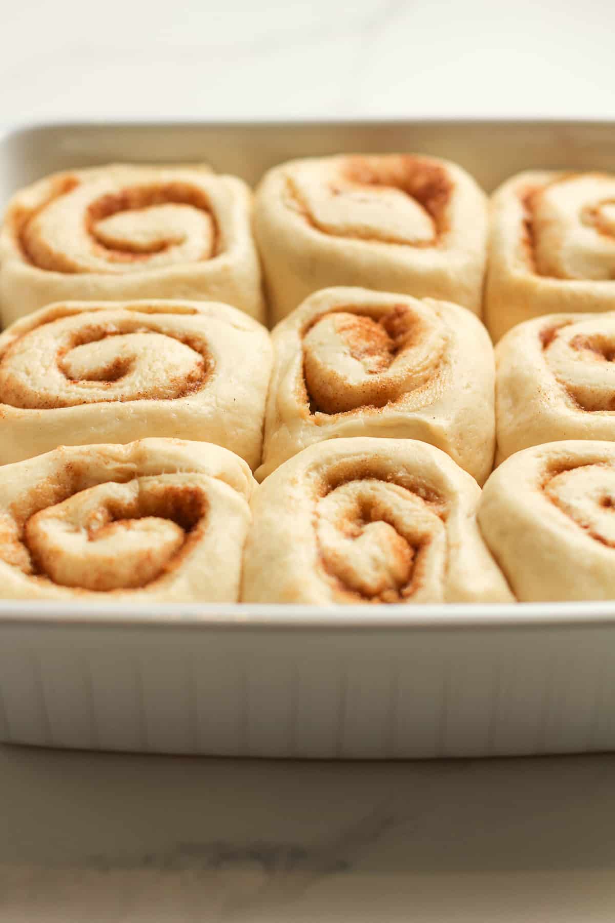 Side shot of the cinnamon rolls in a dish.