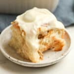 A homemade cinnamon roll with cream cheese frosting.