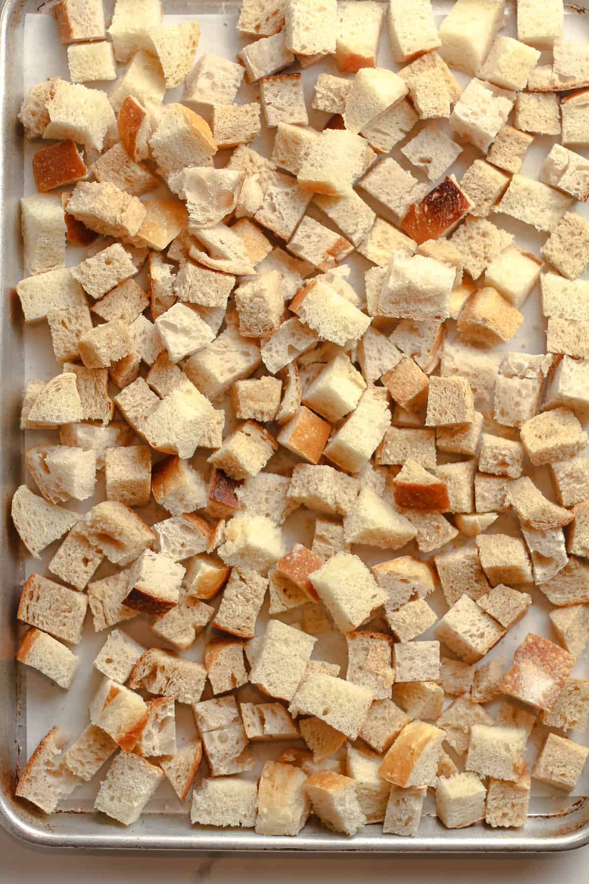 A pan of the dried and cubed bread.