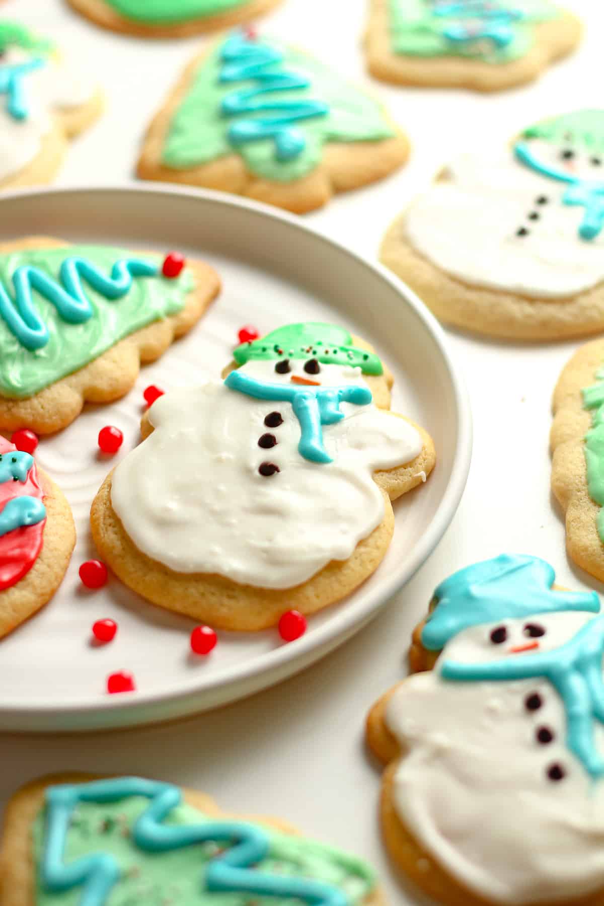 Side shot of the snowman sugar cookie with other cookies around it.