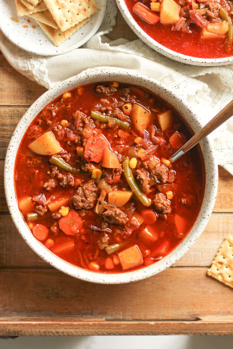 Two bowls of ground beef vegetable soup.