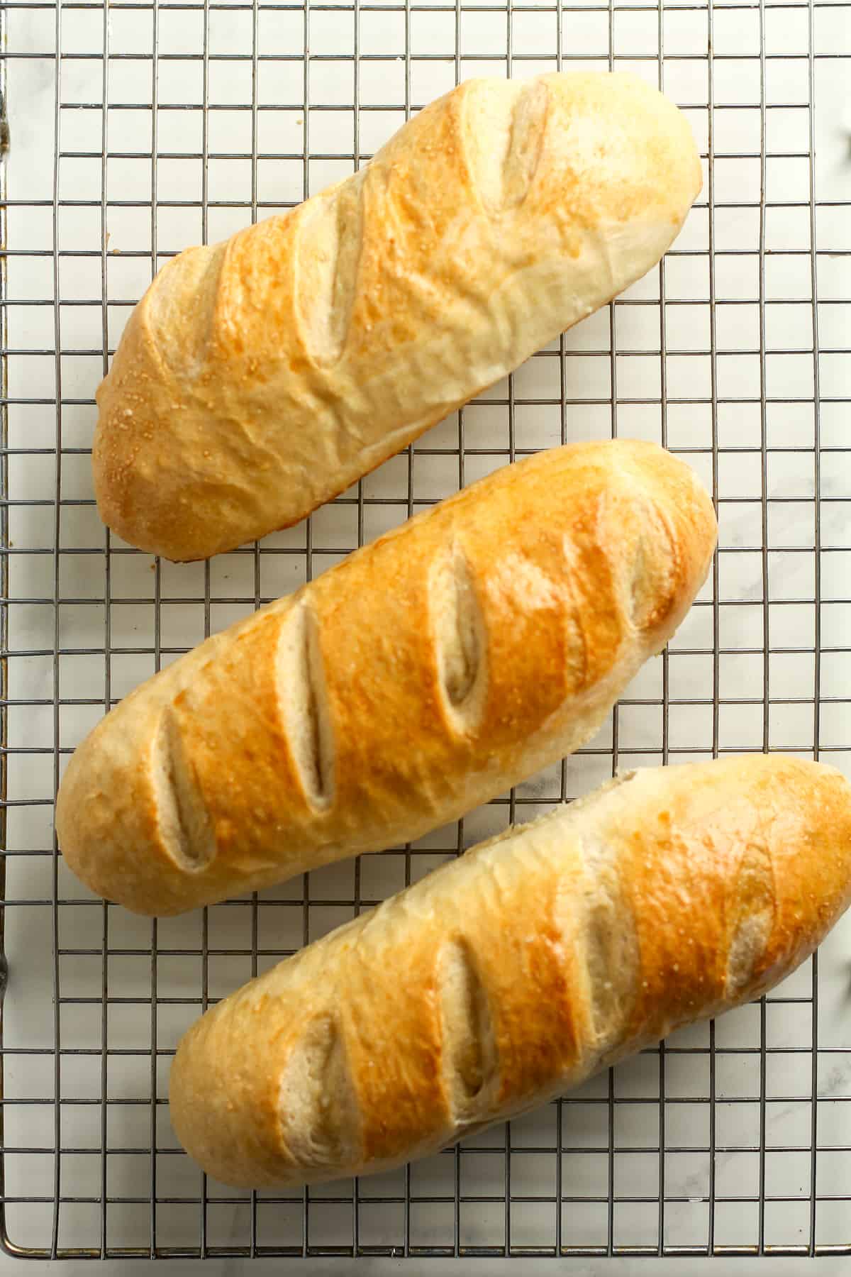 Three baguette loafs of French bread.