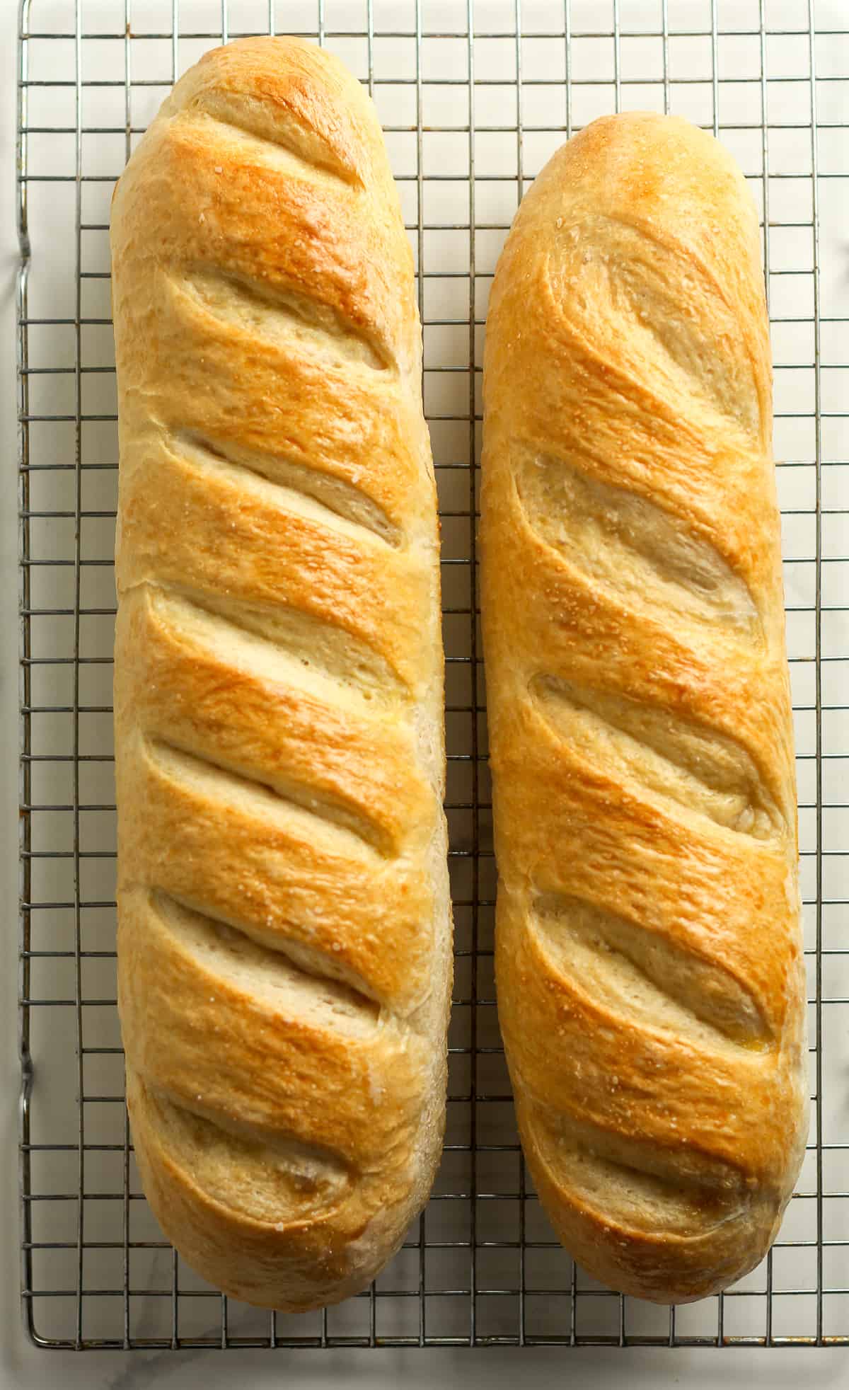 Two loaves of baked French bread.