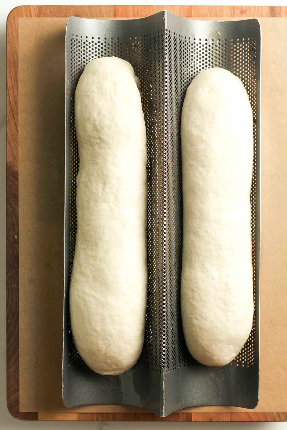 The bread loafs formed on pan.