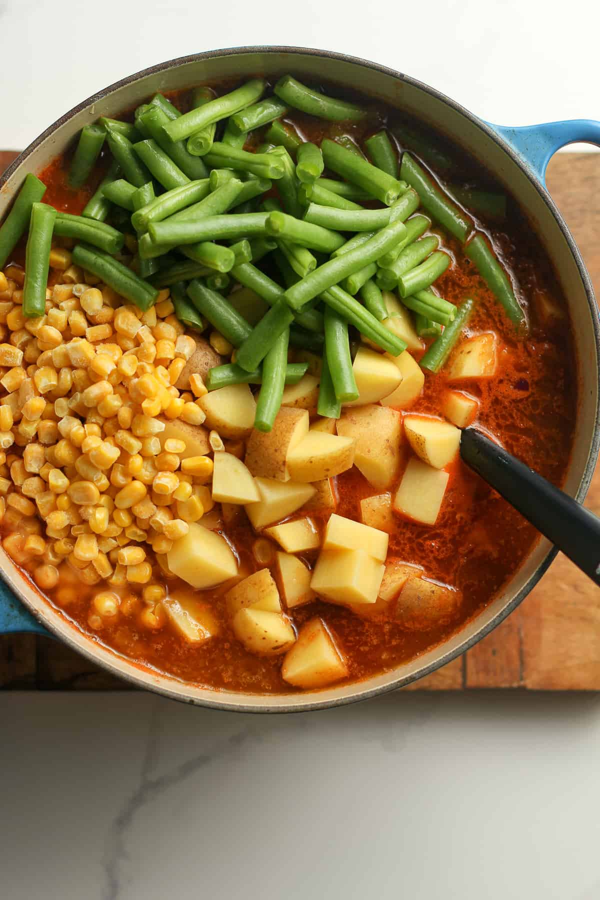 The soup with the corn, beans, and potatoes on top.