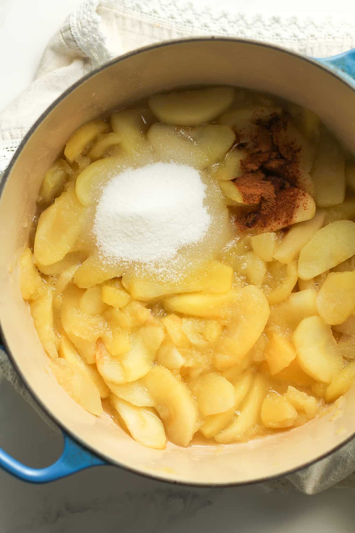 Stock pot of cooked apples with sugar and cinnamon.