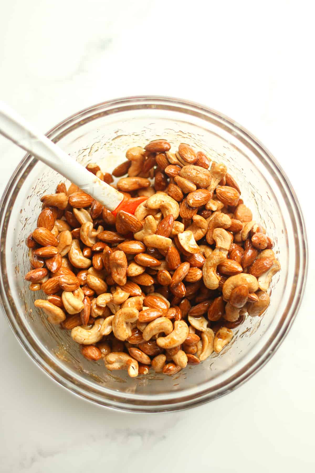 A bowl of the nuts with the ingredients added.