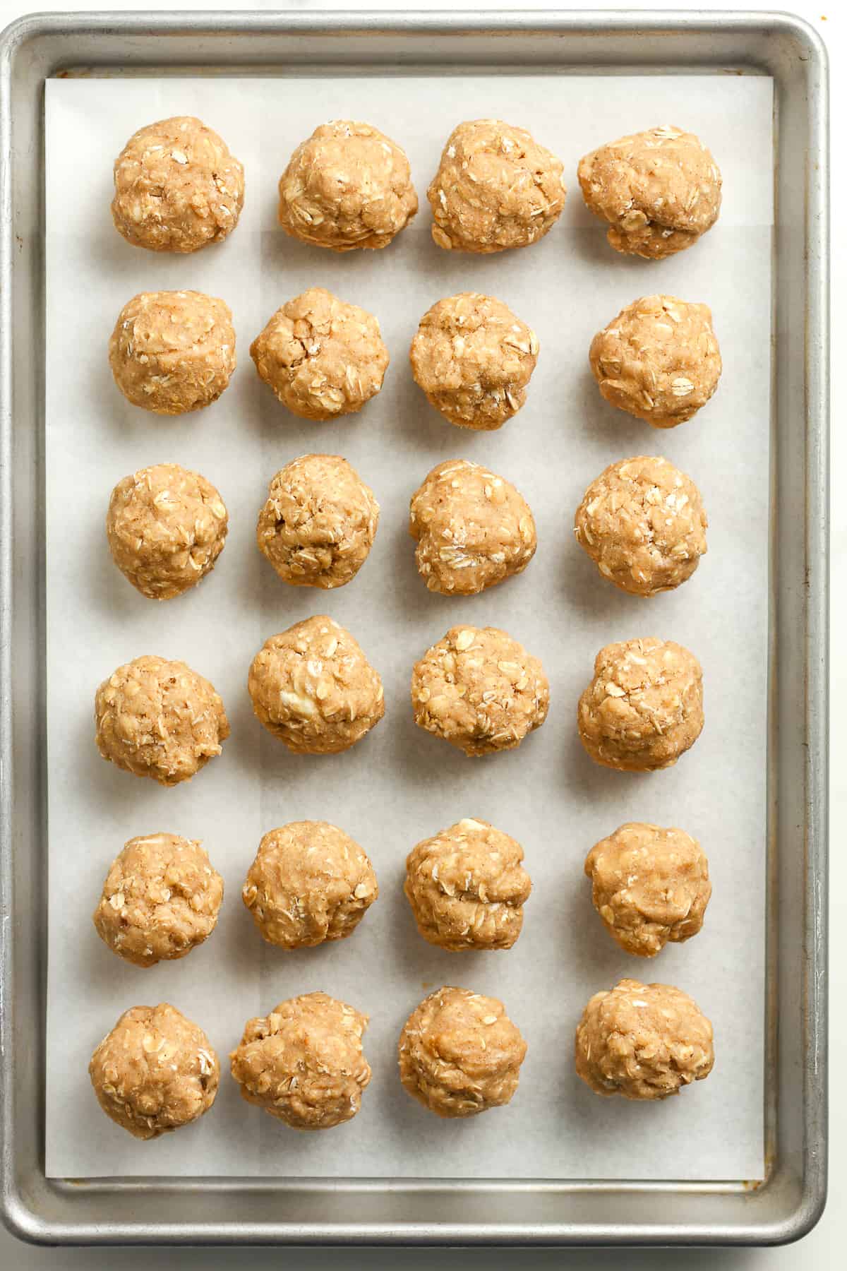 A sheet pan of the oatmeal cookie balls.