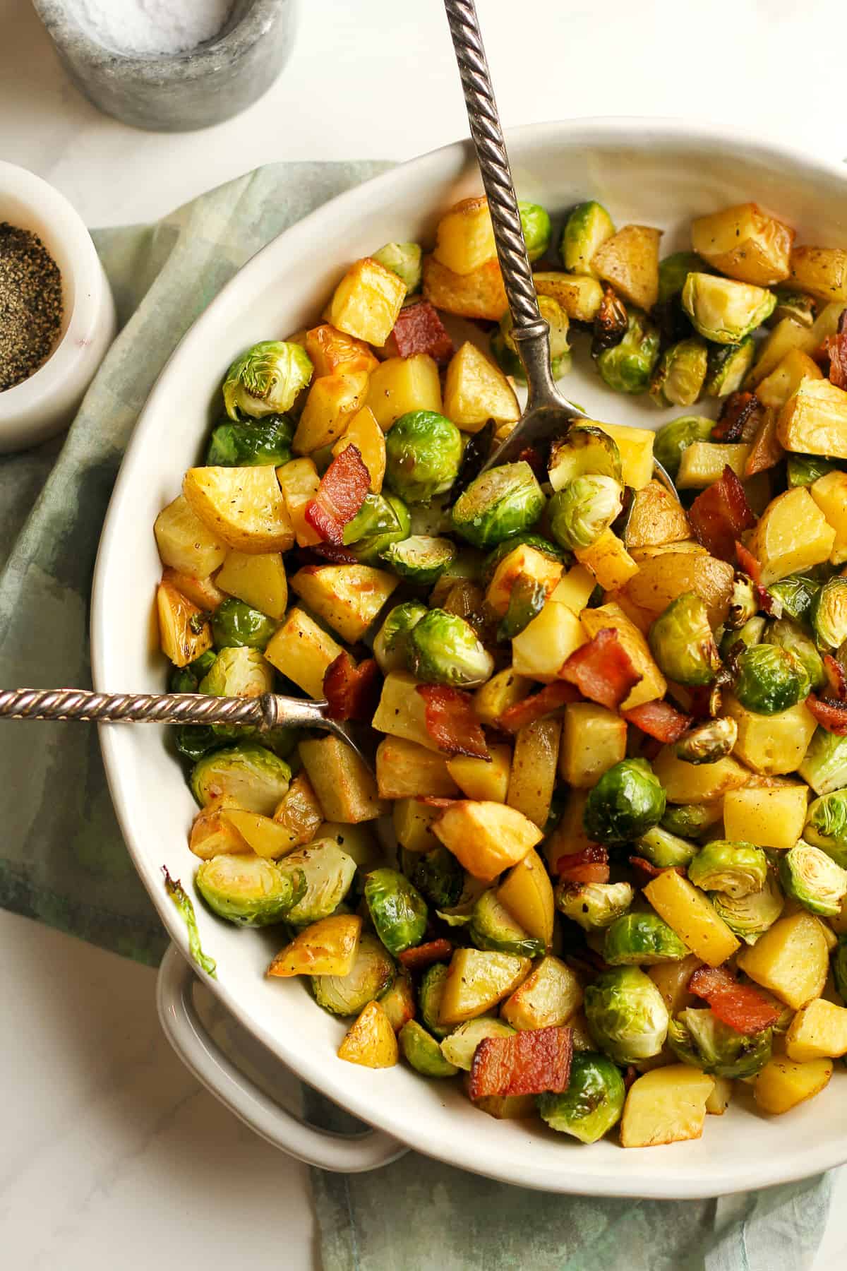 Overhead shot of a bowl of roasted potatoes and Brussels sprouts.