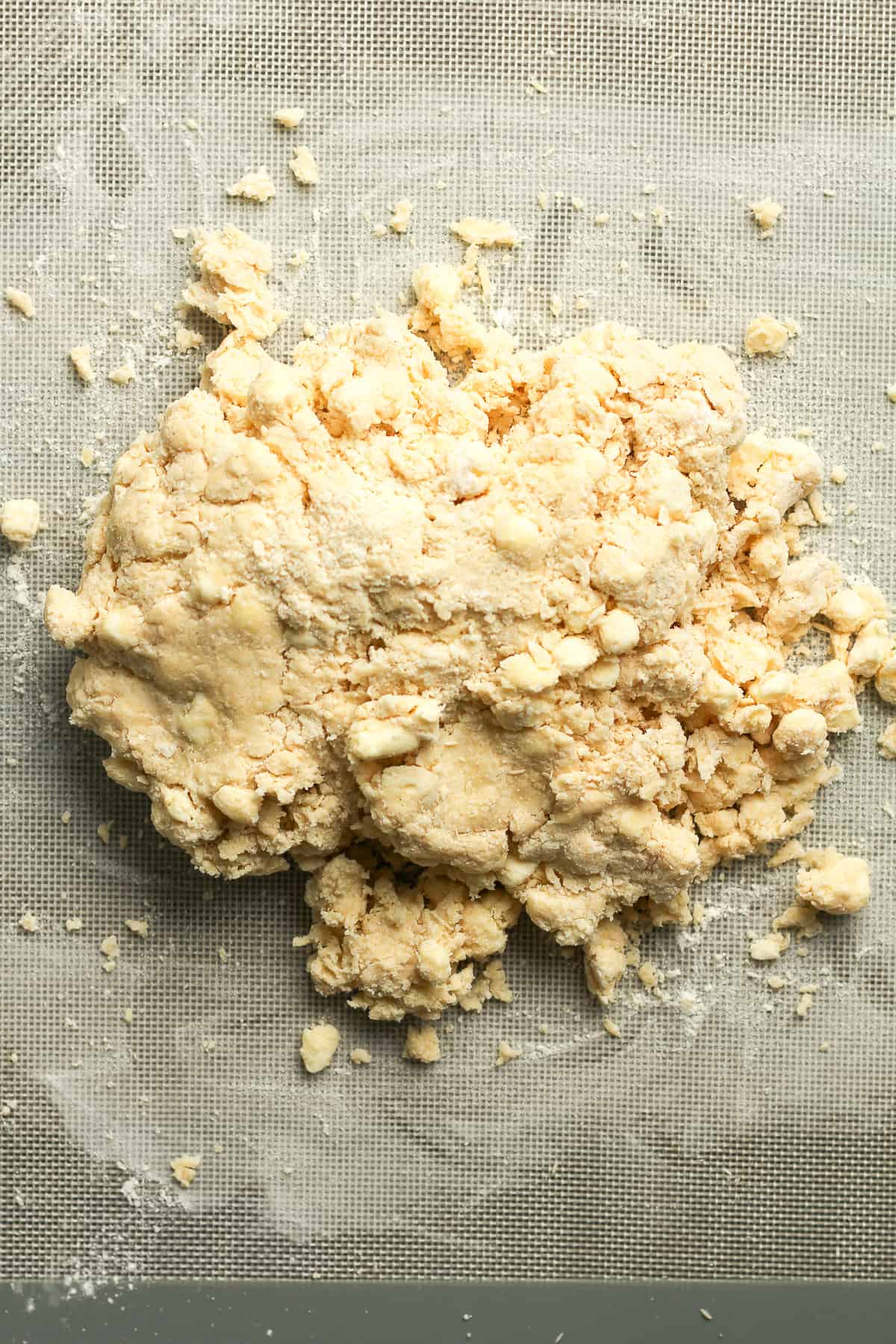 The shaggy scone dough on a baking mat.