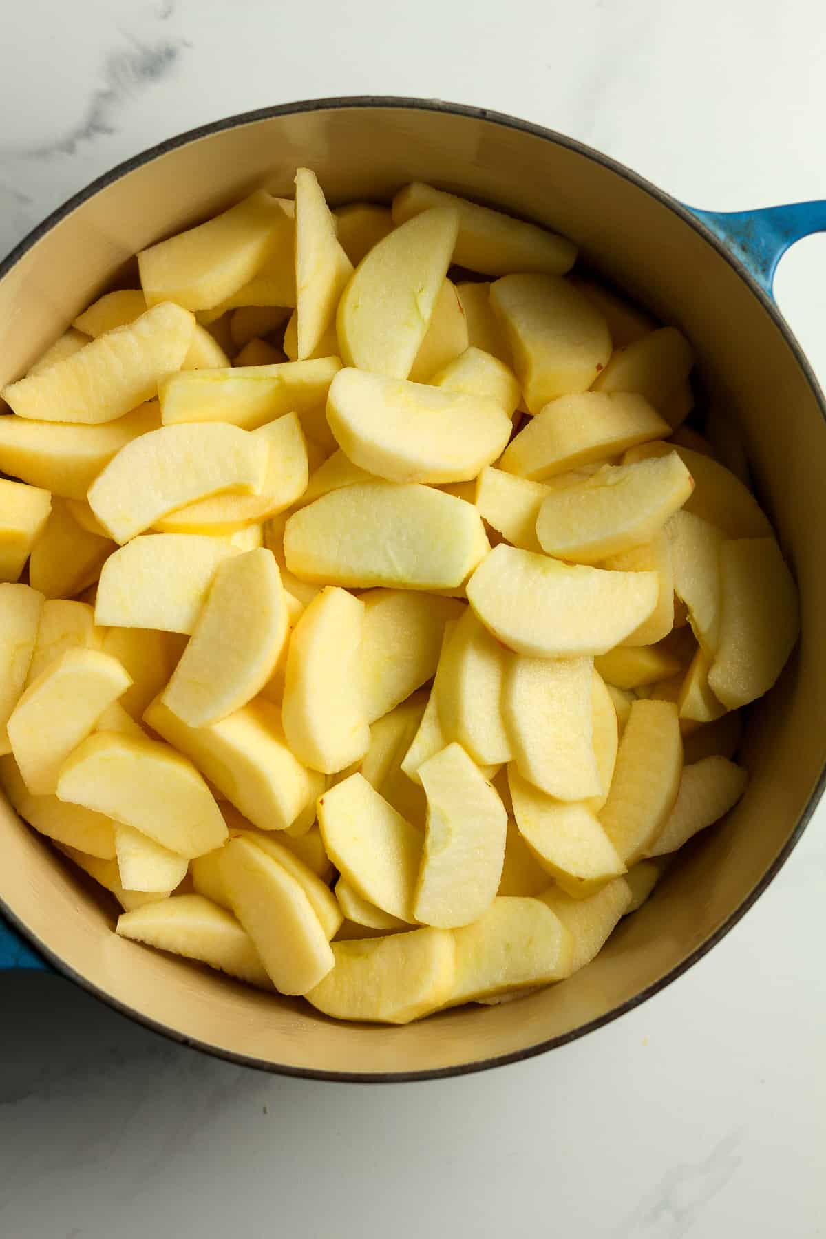 A stock pot of the sliced apples.