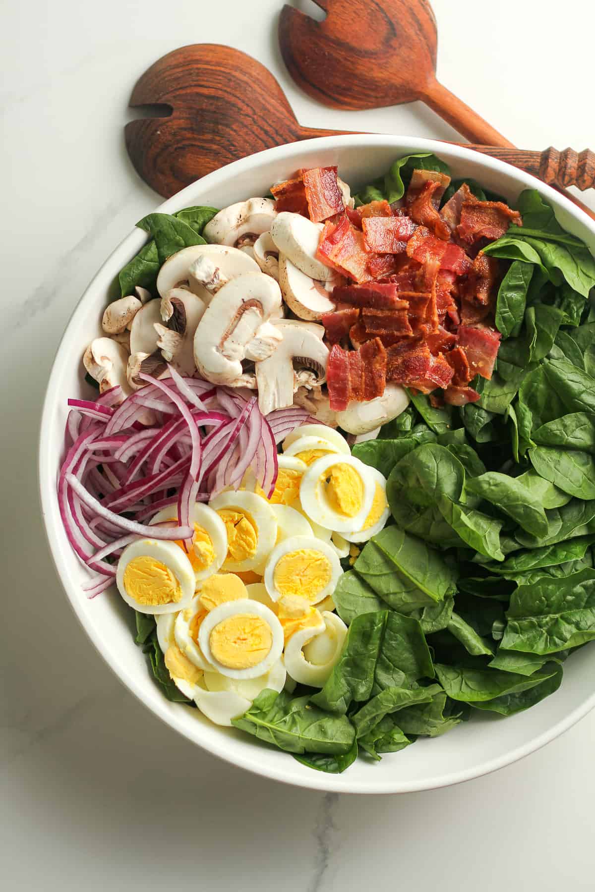 The bowl of the spinach salad, by ingredients.