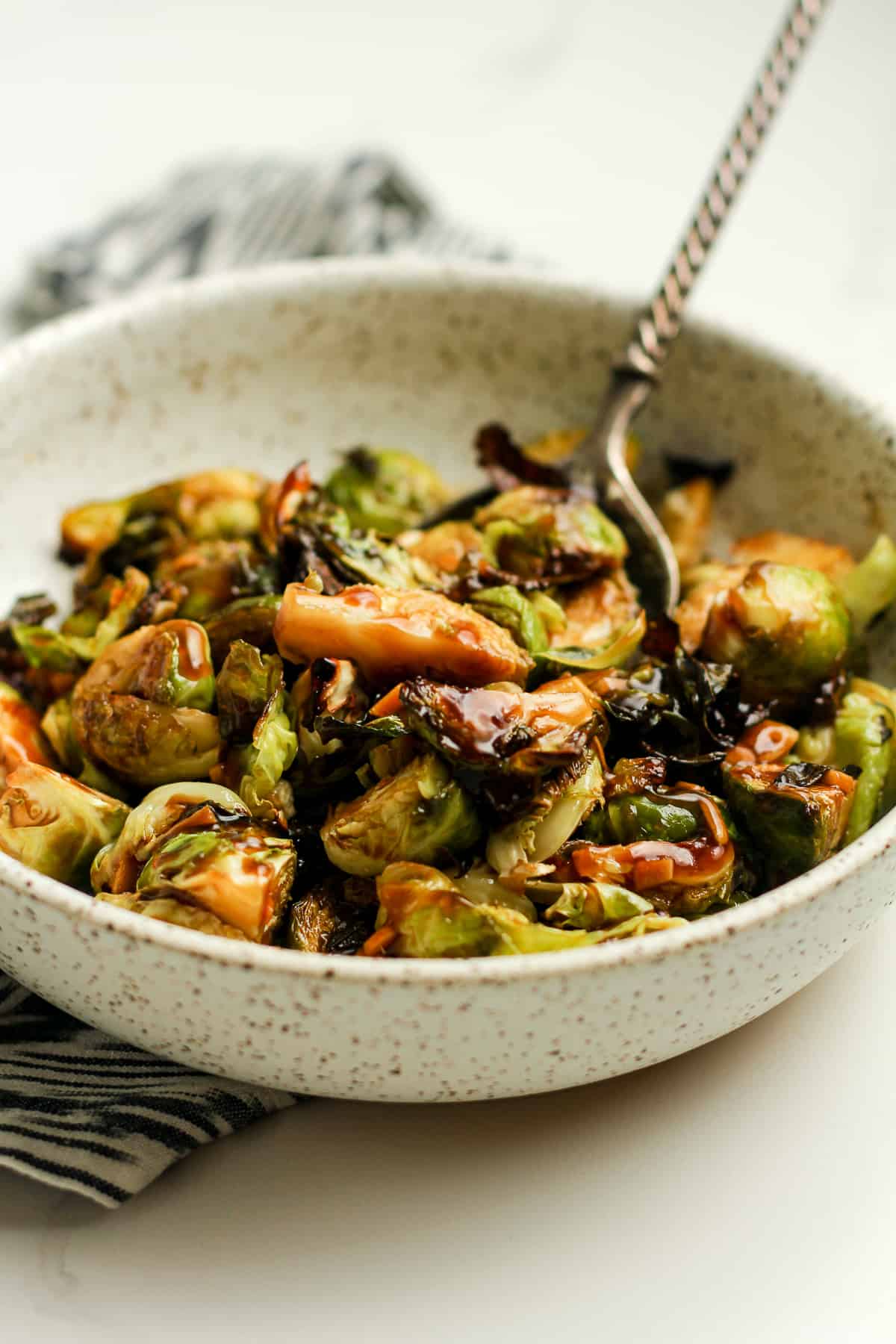 Side shot of the Brussels sprouts with a spoon.