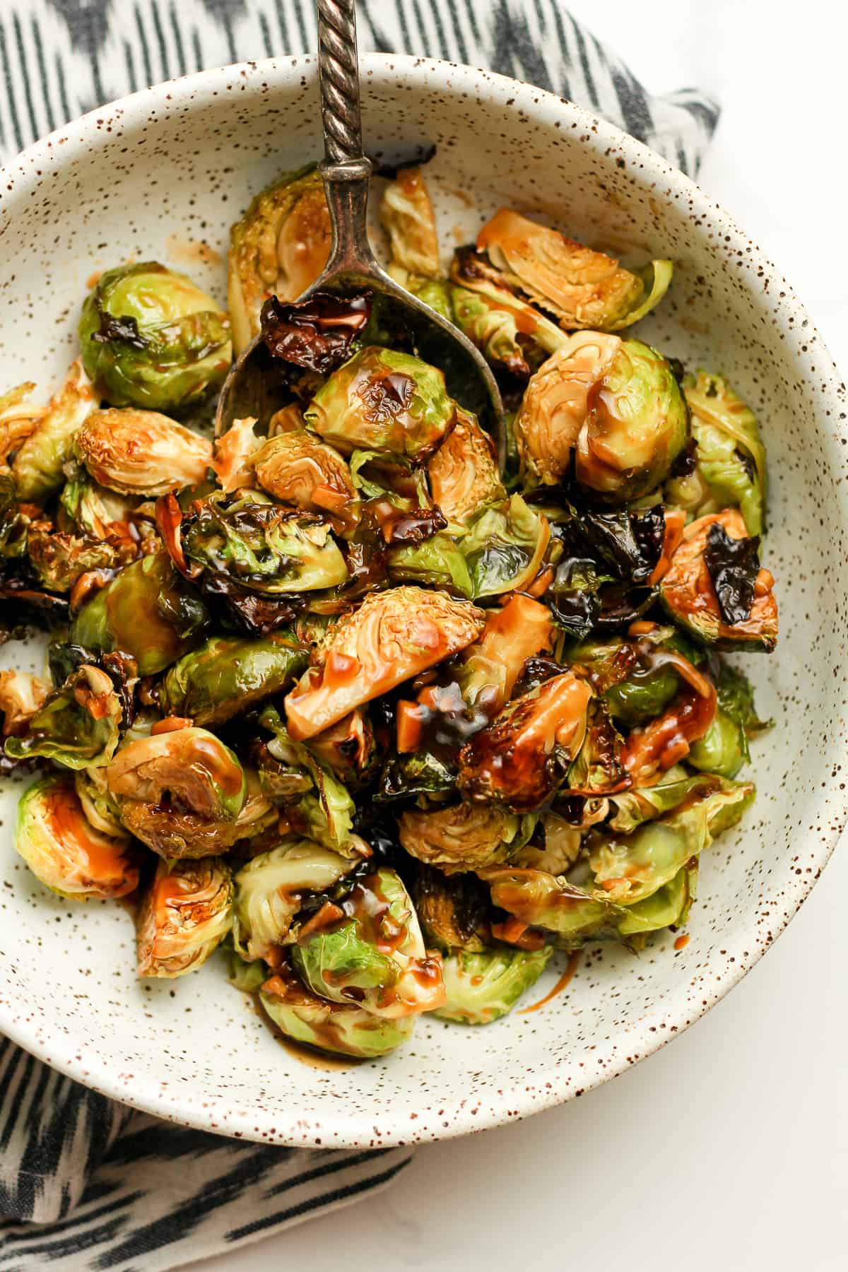 Closeup of the roasted Brussels sprouts with a spoon.