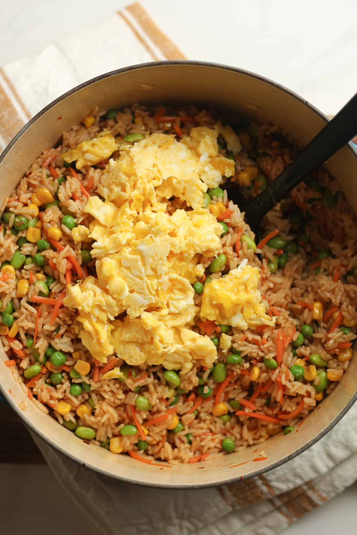 A stock pot of the fried rice plus eggs on top.