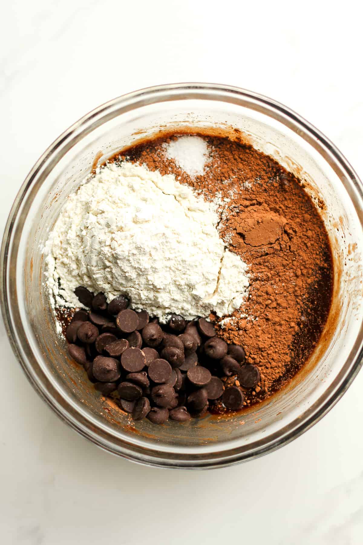 A bowl of the chocolate wet mixture plus dry ingredients on top.