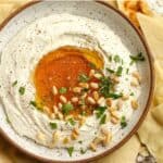 A bowl of the whipped feta dip with honey and pine nuts.