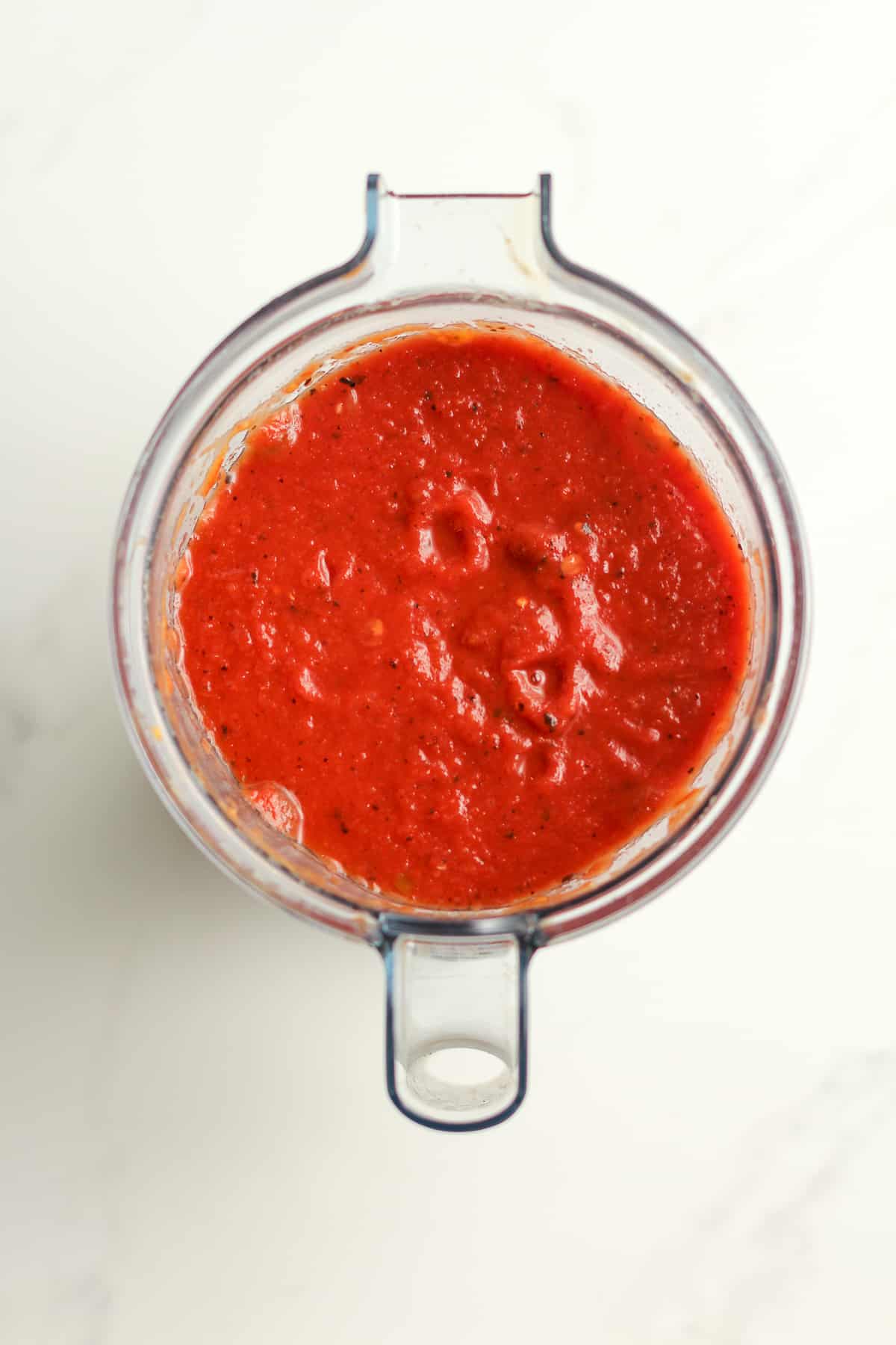 A blender with the just blended tomatoes.