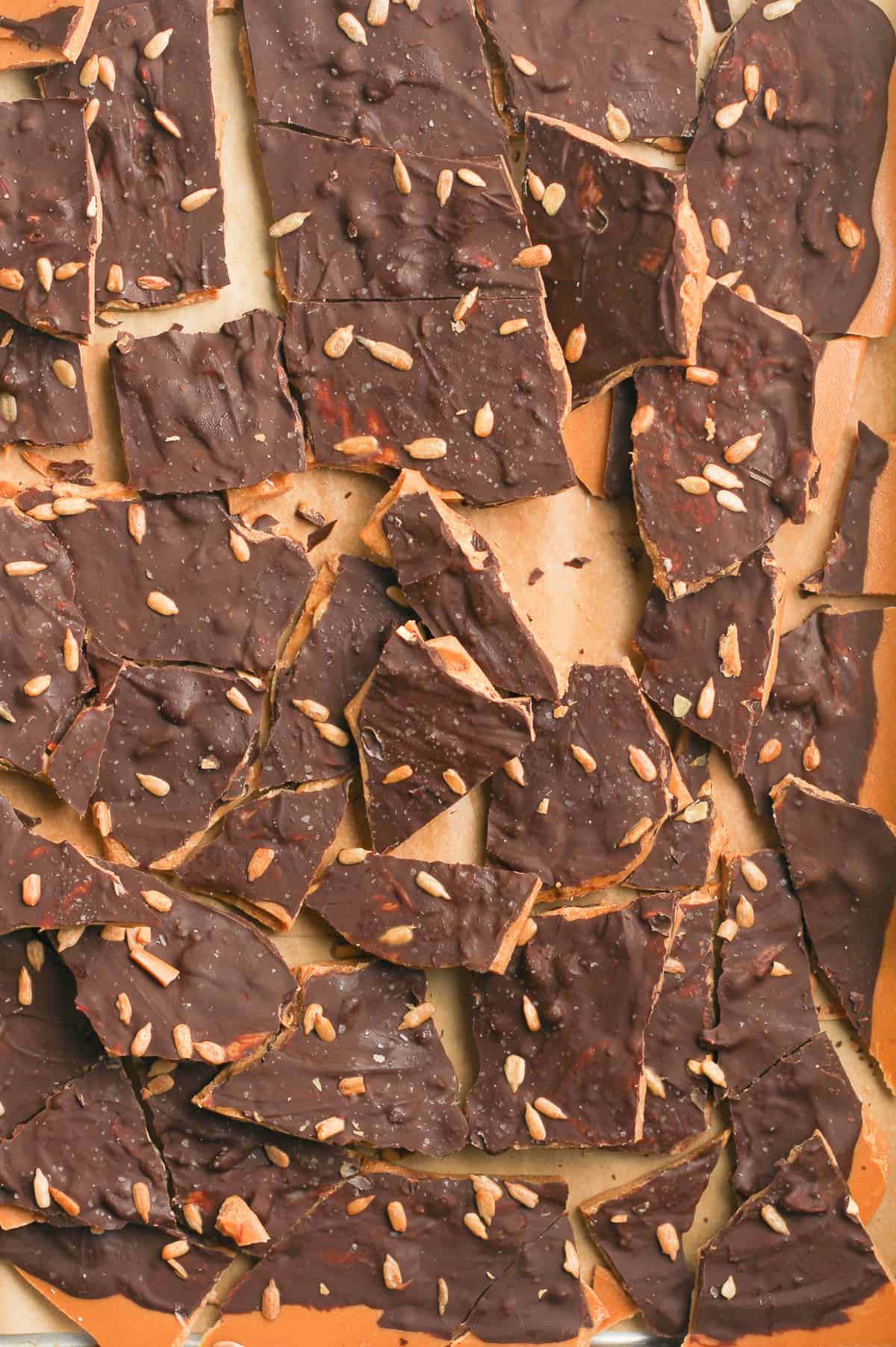 The broken up dark chocolate toffee on a pan.