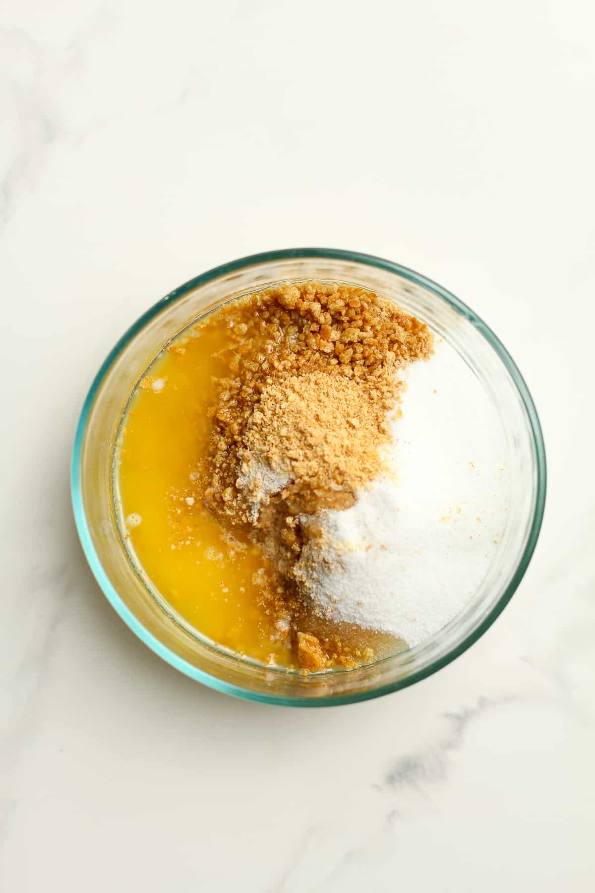 A bowl of the ingredients for the graham cracker crust, before combining.