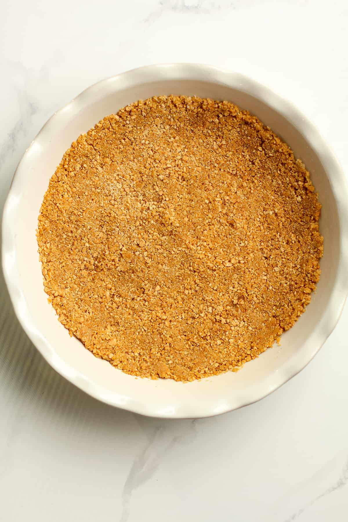 A pie plate with a graham cracker crust.
