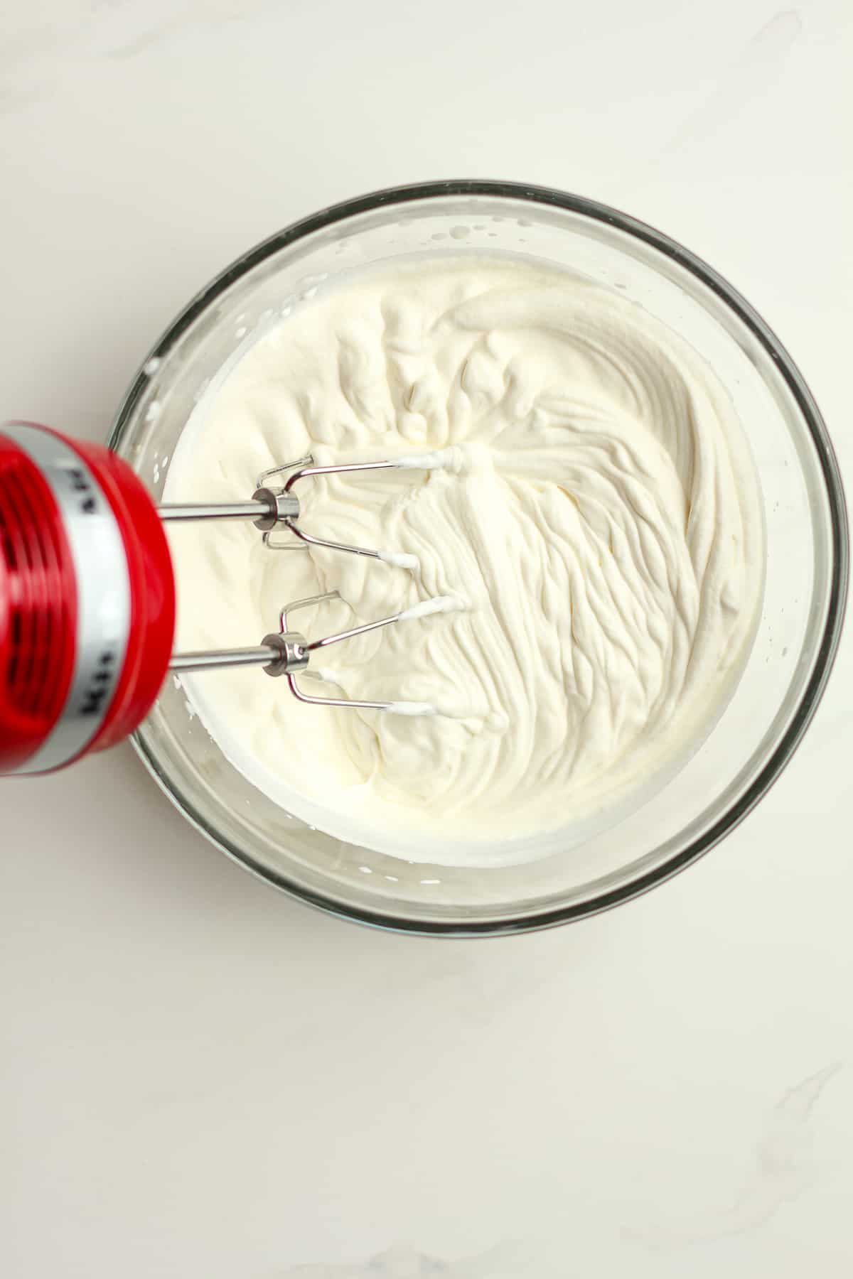The homemade whipping cream in a bowl.