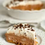 Side view of a slice of French Silk Pie on a graham cracker crust.