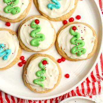A plate of frosted sugar cookies, decorated with Christmas trees.