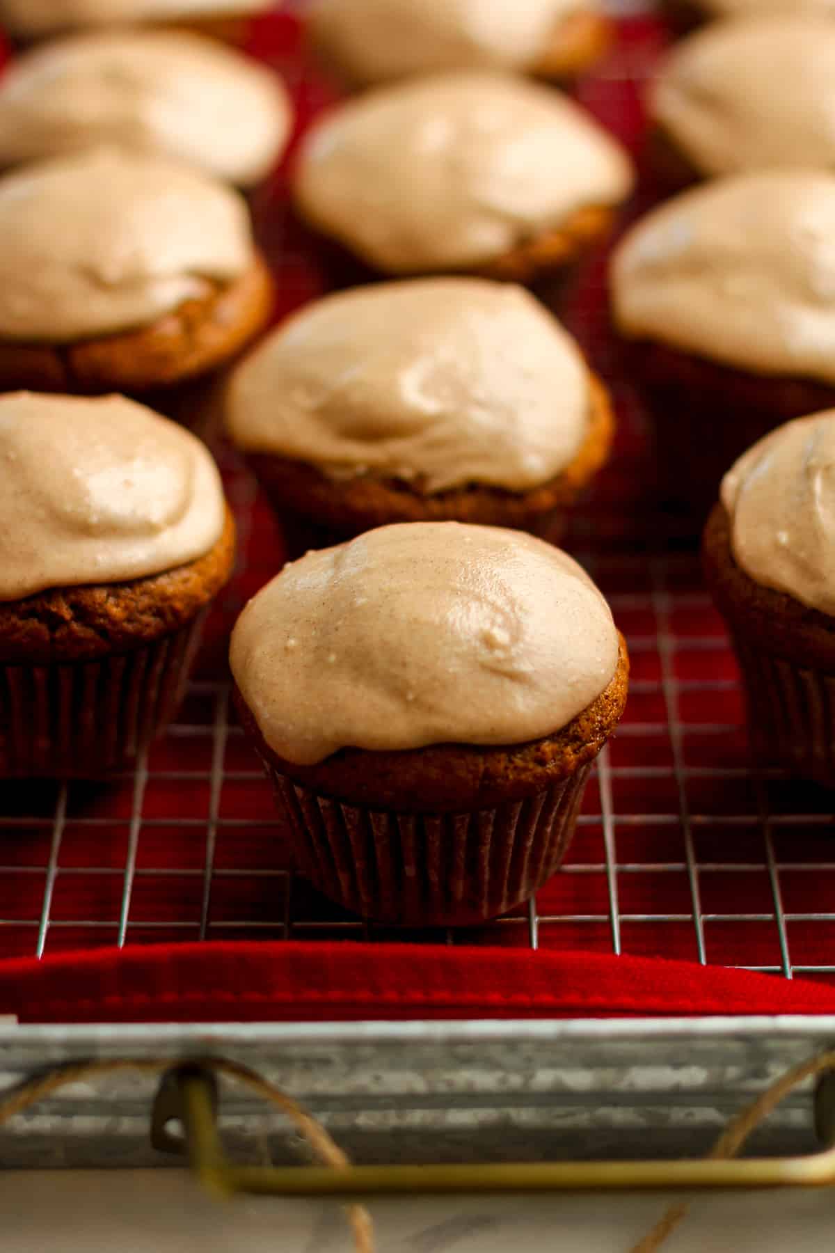 Side shot of a tray of gingerbread muffins with cinnamon icing.